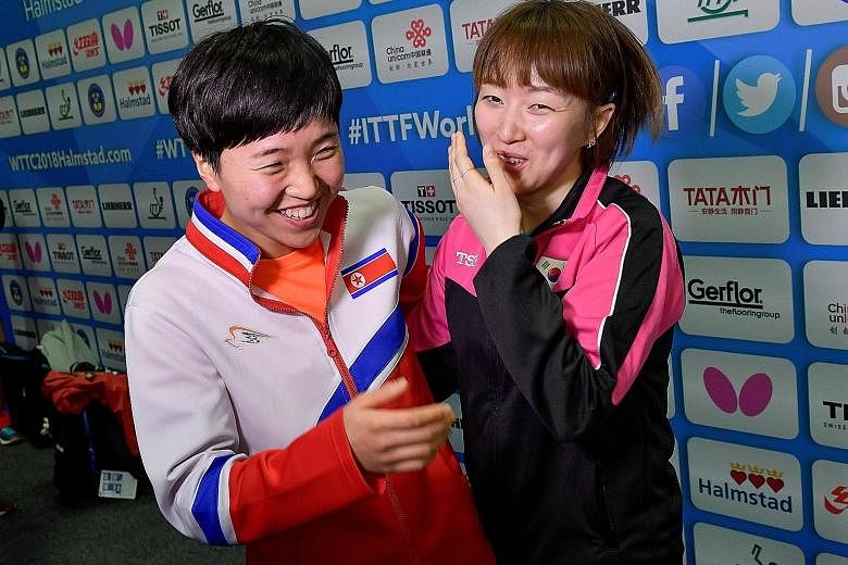 Suh Hyo Won of South Korea (far right) and Kim Song I of North Korea sharing a light moment after a news conference in Halmstad, Sweden, yesterday.