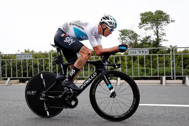 British rider Chris Froome pedalling on after crashing during reconnaissance of the 9.7km first-stage route of the Tour of Italy around Jerusalem yesterday. He received treatment and was cleared to race.