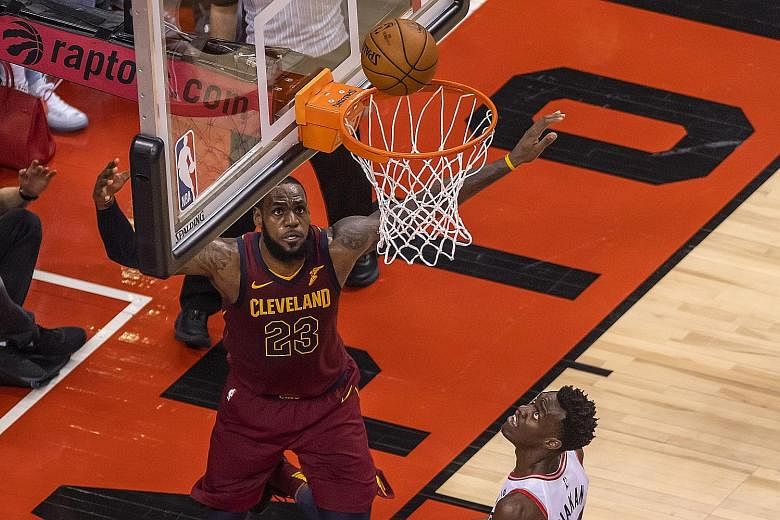 Cleveland Cavaliers' LeBron James watching the ball drop into the basket in front of Toronto Raptors' Pascal Siakam during the third quarter in Game 2 of the NBA Eastern Conference semi-final series at the Air Canada Centre in Toronto.