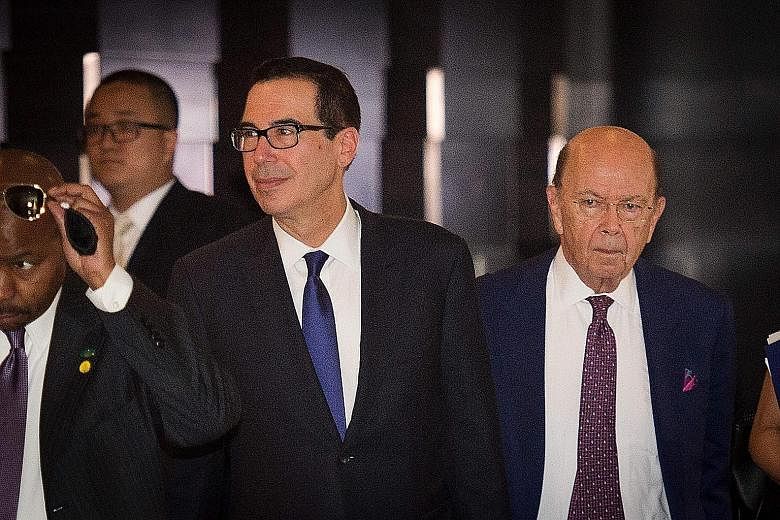 US Treasury Secretary Steven Mnuchin (far left) and Commerce Secretary Wilbur Ross in Beijing yesterday. The US delegation was in China to soothe trade tensions after both sides threatened to slap additional tariffs worth billions of dollars on each 