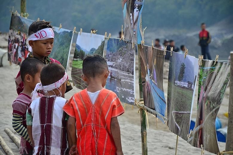 Children (above) join an event calling for the halt of dam-building on the Salween river (left). Several sites along the major waterway have been earmarked for hydropower dams, including the Mong Ton Hydropower project.