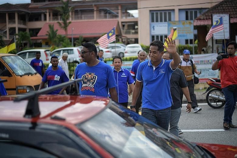 Mr Khairy Jamaluddin, one of the most recognisable faces of ruling coalition Barisan Nasional, greeting residents during a walkabout in Seremban last Thursday.