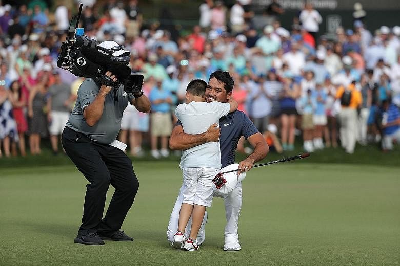 Jason Day of Australia celebrating with his son Dash on the 18th green at Quail Hollow Club after winning the Wells Fargo Championship in North Carolina on Sunday. The victory elevated the 30-year-old to world No. 7 yesterday after a winless 2017.
