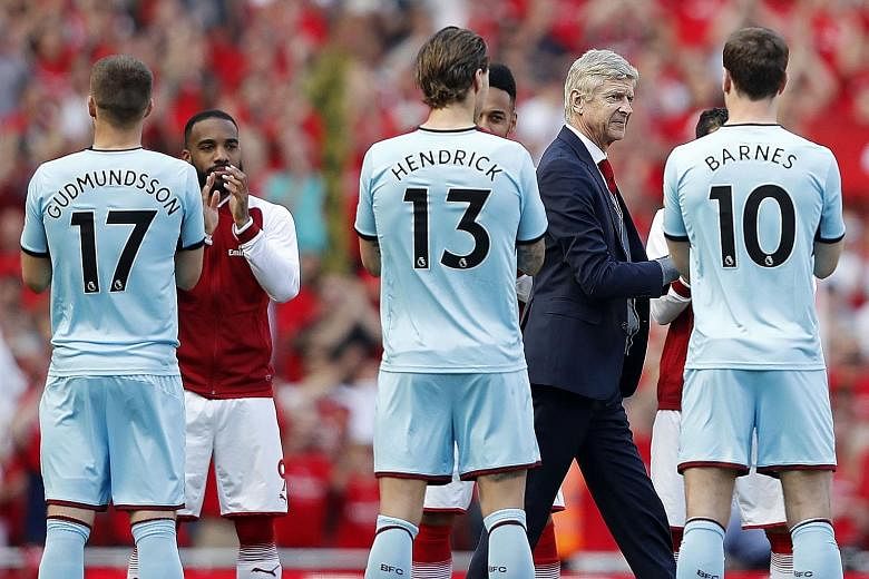 From top: Arsenal's French manager Arsene Wenger giving his tie to a young fan who had a placard with the words - Arsene, can I have your tie - during the lap of honour after Sunday's 5-0 win over Burnley. Wenger receiving a guard of honour from the 
