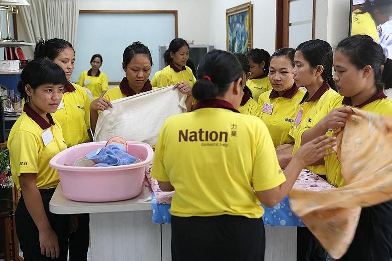 Maids being trained at an employment agency here. The new performance bond of $6,000 imposed by the Indonesian Embassy on employers here who hire maids from Indonesia took effect last month.