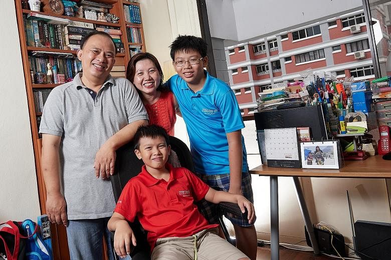 Xavier Wong (seated), 10, with his parents Anthony Wong and Angela Lee, and older brother Zachary. Xavier can solve maths problems meant for children two years older than he is and is a member of high-IQ society Mensa. But he also has mild attention-