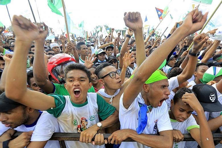 Supporters of Parliamentary Majority Alliance - comprising the National Congress for Timorese Reconstruction, People's Liberation Party and youth-based Khunto party - at a campaign rally in Tasitolu, Dili, in Timor-Leste, on Tuesday.