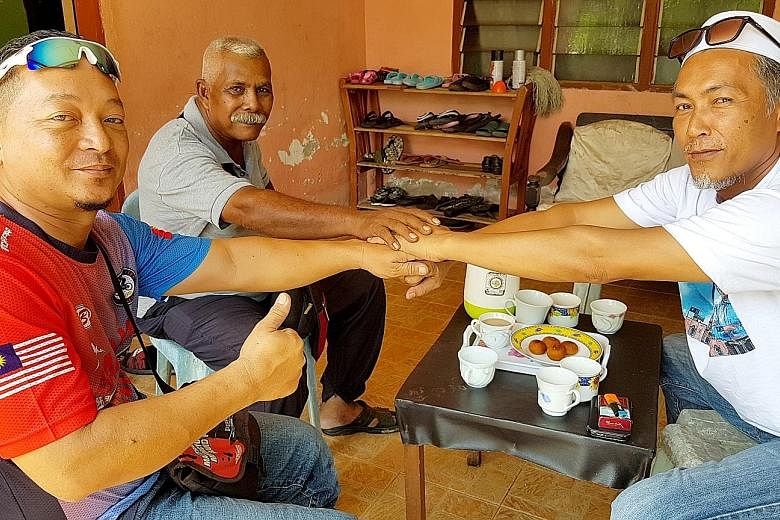 Friends (from far right) Ahmad Tarmizi Din, Bahadun Salim and Effendi Yakob, who all voted for different parties in Wednesday's election, having breakfast together in Kedah yesterday. Supporters of Tun Dr Mahathir Mohamad cheering him outside the She