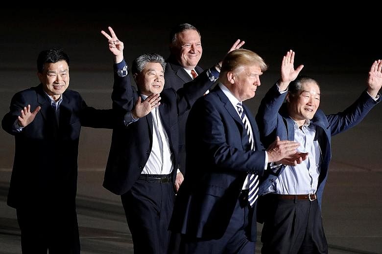 US President Donald Trump and Secretary of State Mike Pompeo with the three US citizens freed by North Korea (from left) Tony Kim Sang Duk, Kim Hak Song and Kim Dong Chul (right), upon their arrival at Joint Base Andrews, in Maryland. The release of 