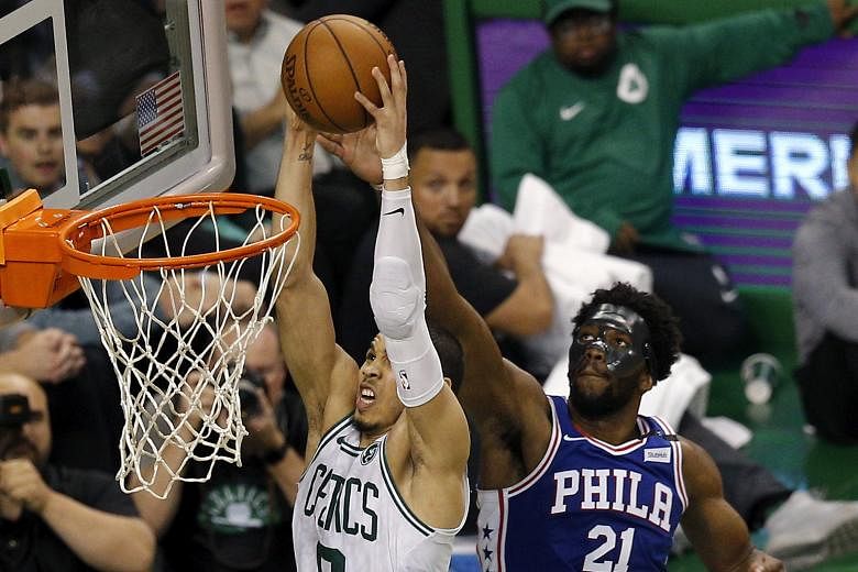 Philadelphia centre Joel Embiid failing to stop Boston forward Jayson Tatum from attacking the basket at the TD Garden on Wednesday.