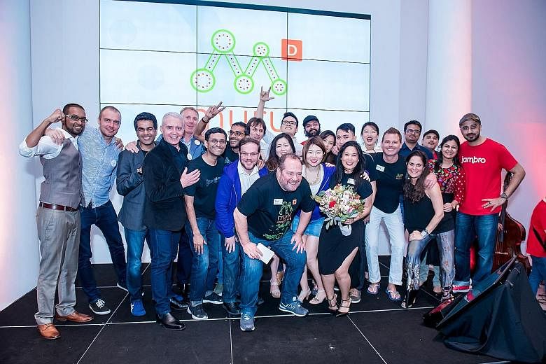 Muru-D Singapore head Paul Meyers (front) with members of the 10 graduating start-ups. Under the programme backed by Australian telco Telstra, Singapore firms CarePod, Idem Hospitality, Know and Vybes each got $75,000 in funding, mentorship, training