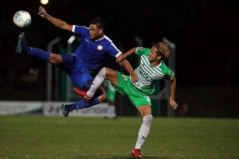 Bottom club Geylang International's Fumiya Kogure (in green) tussling with Young Lions' Irfan Fandi on Wednesday. The teams drew 1-1.