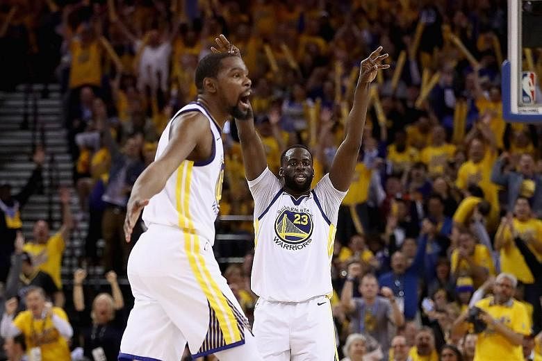 Kevin Durant (left) of the Golden State Warriors and Draymond Green reacting after Stephen Curry (not pictured) made a shot against the New Orleans Pelicans during Game 5 of the Western Conference semi-finals. The Warriors will face the Houston Rocke