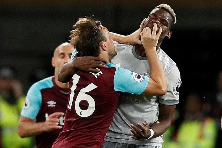 West Ham United's Mark Noble (far left) and Manchester United's Paul Pogba attempting a late version of boxing's Golden Gloves in the EPL match at the London Stadium on Thursday.