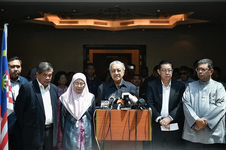 Tun Dr Mahathir Mohamad giving a press conference yesterday at Yayasan Albukhary in Kuala Lumpur with Pakatan Harapan leaders (from left) Anthony Loke, Mohamad Sabu, Wan Azizah Wan Ismail, Lim Guan Eng and Saifuddin Abdullah. Dr Mahathir's son Mukhri