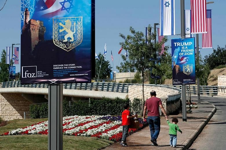 Posters praising President Donald Trump hanging along the streets near the new US embassy in Jerusalem. When embassy staff move in, 450 retirees, including Madam Bela Winokul (above), will lose their home.