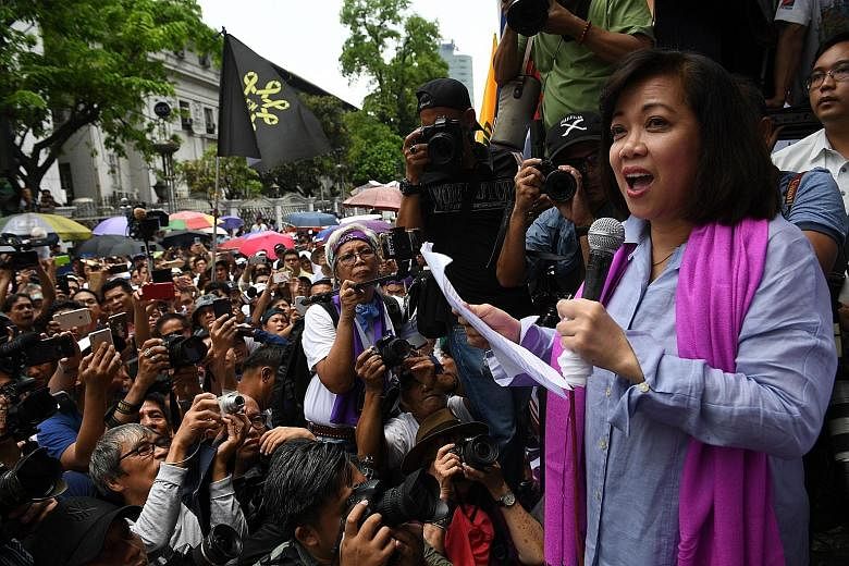 Ousted Philippine chief justice Maria Lourdes Sereno addressing her supporters in front of the Supreme Court building in Manila yesterday. One opposition party said the ouster of Ms Sereno, the country's first female chief justice, left behind a "pup