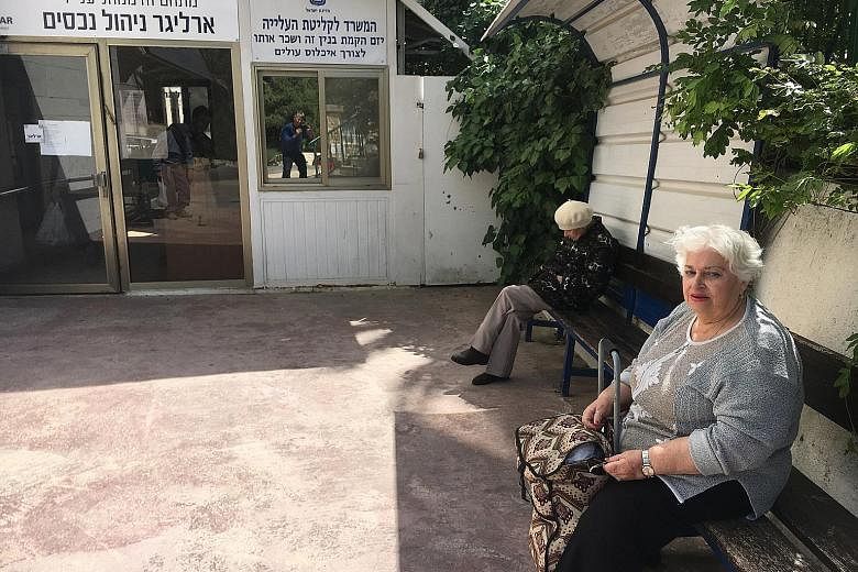 Posters praising President Donald Trump hanging along the streets near the new US embassy in Jerusalem. When embassy staff move in, 450 retirees, including Madam Bela Winokul (above), will lose their home.