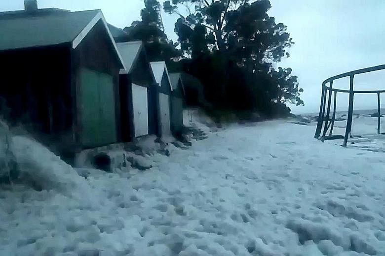 Buildings affected by flooding yesterday along the shore at Taroona, Tasmania, in a still image taken from a video obtained from social media.