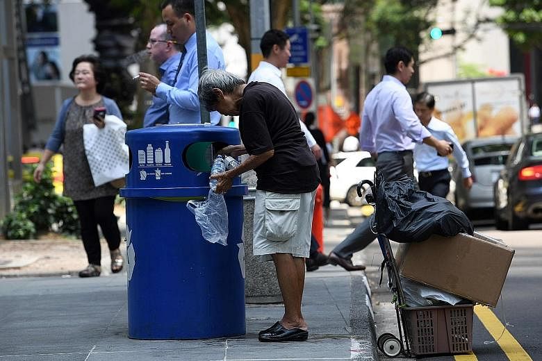 A woman looking for waste to recycle in Raffles Place. In a March survey, 69 per cent of Singaporeans polled said income inequality has worsened in the past five years, while 31 per cent felt it has become better.