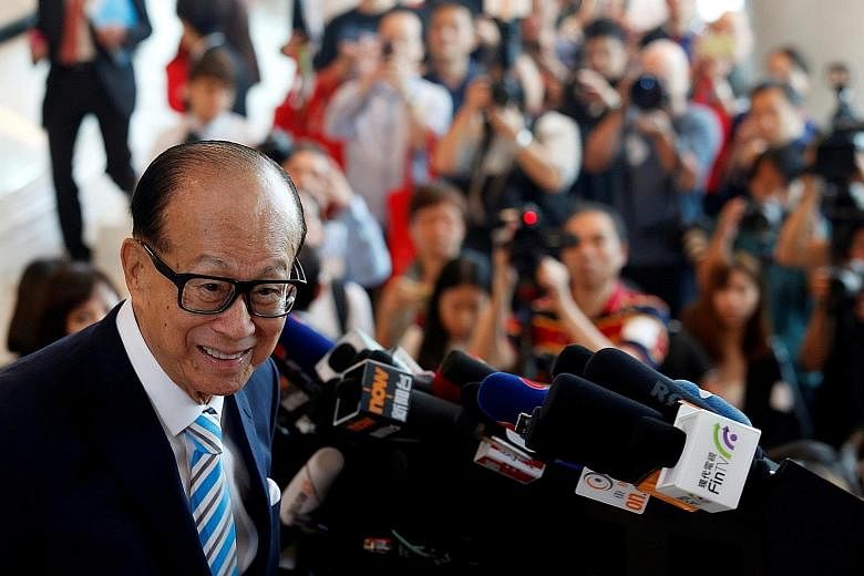 Hong Kong tycoon Li Ka Shing, chairman of CK Hutchison Holdings, meeting the press on Thursday after he formally retired at the company's annual general meeting in Hong Kong. His retirement, passing the baton to his elder son Victor Li, is the most h