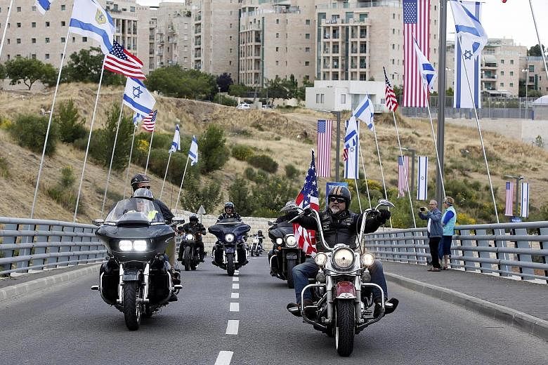 Israeli Harley Davidson bikers yesterday arriving outside the US consulate building in Jerusalem that will become the official US embassy from today.