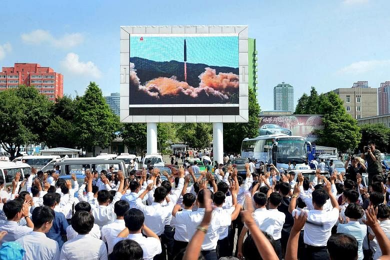 A file photo from July last year showing a public broadcast of North Korea's test launch of an intercontinental ballistic missile. To uphold its pledge to discontinue such nuclear and weapons tests, the North has scheduled the dismantlement of its nu