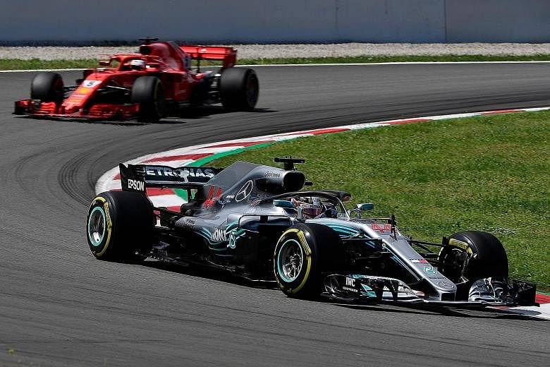 Mercedes' Lewis Hamilton (front) and Ferrari's Sebastian Vettel competing in the Spanish Grand Prix yesterday. Hamilton has a 17-point lead over Vettel following his win.