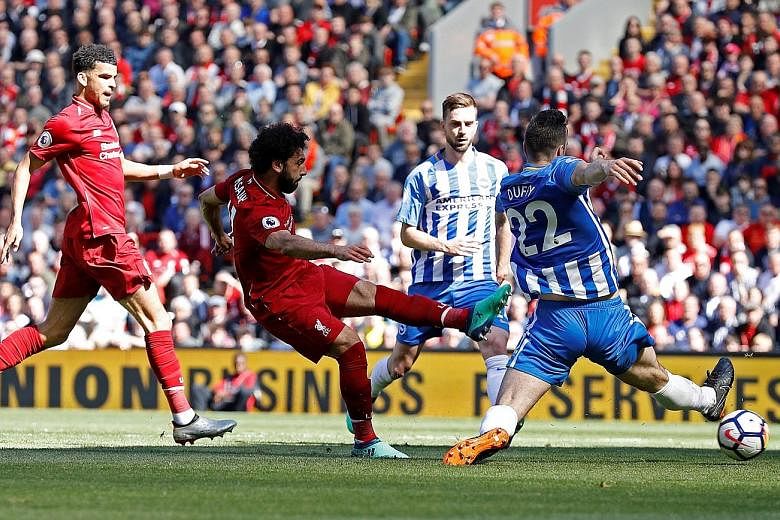 Mohamed Salah scoring the first goal in Liverpool's 4-0 win against Brighton yesterday. Having gone three matches without a goal, the Egyptian overtook the trio of Alan Shearer, Cristiano Ronaldo and Luis Suarez, who shared the previous best in a 38-