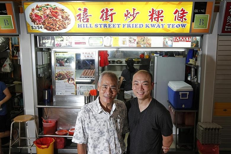Mr Ng Chang Siang (left), owner of the popular Hill Street Fried Kway Teow at Block 16 Bedok South Road, with his son, Mr Ng Yeow Kiat, in a 2013 photo.