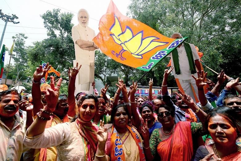 BJP supporters celebrating their party's success in the Karnataka elections in Bangalore yesterday. Both the Bharatiya Janata Party and the Congress have said they will form the state government in an election where much is at stake for them. Without