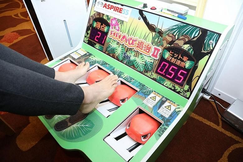 The SmarTable (left) has six games that help to improve memory, accuracy in hand movement and response times of those with cognitive impairment, while The Doki Doki Snake Extermination game (right) is similar to the Whac-A-Mole arcade game. As snakes