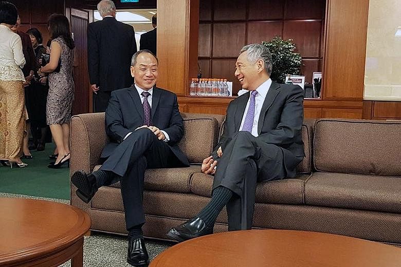 Prime Minister Lee Hsien Loong chatting with former Workers' Party chief Low Thia Khiang in Parliament House last week at the reopening of Parliament.
