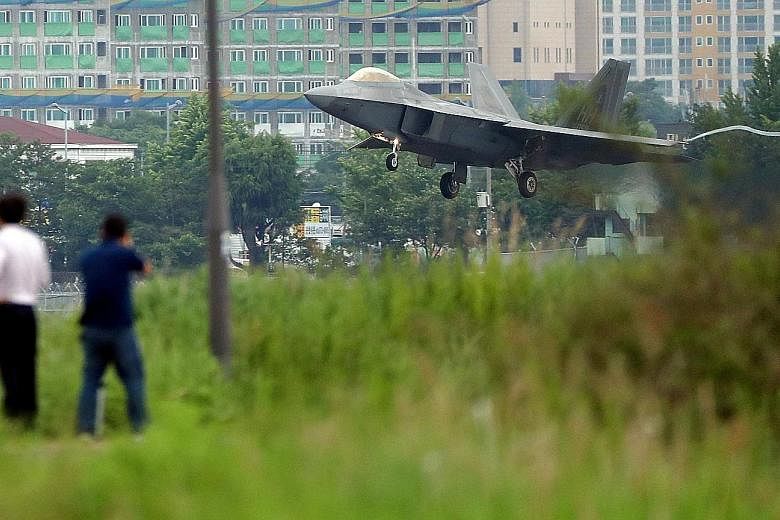 A US Air Force F-22 Raptor fighter jet landing in Gwangju, South Korea, yesterday. The Pentagon has downplayed ongoing military exercises with South Korea, describing them as routine and defensive.