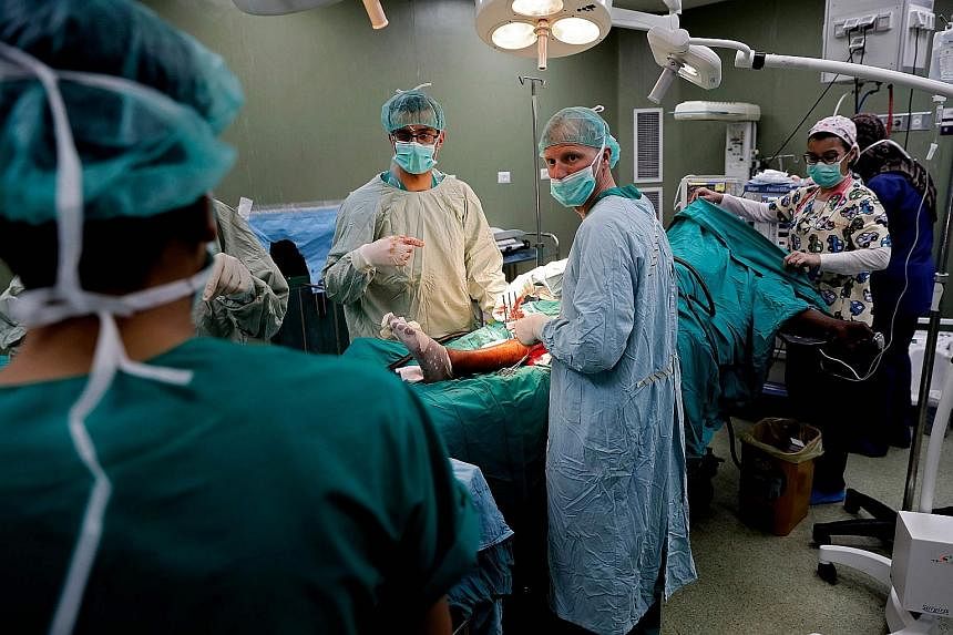 Surgeons from medical charity Doctors without Borders performing surgery at a hospital in Deir al-Balah, Gaza, on a Palestinian man who had received a bullet in his leg during Monday's protests. An alliance of international medical-aid organisations 