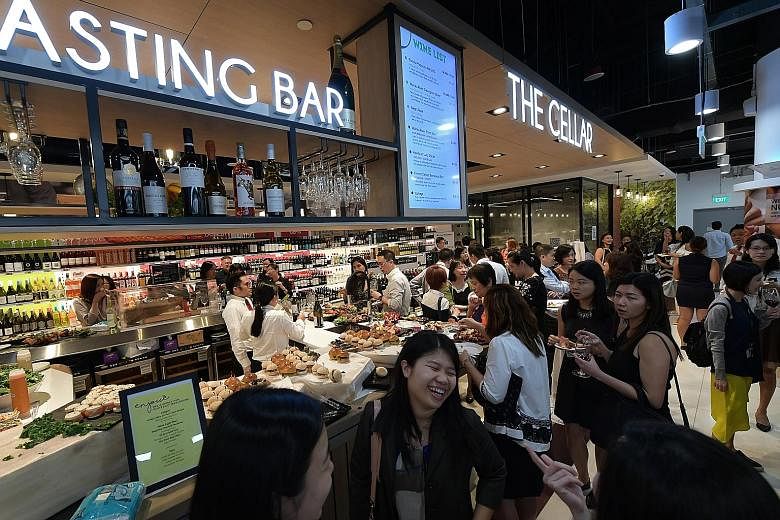 A tasting bar at the new Cold Storage outlet at Fusionpolis. In line with the communal and experiential concept of the retail hub, the supermarket added two function rooms and a place where people can dine.