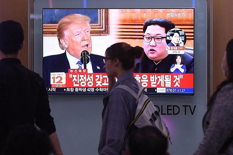 A television news screen showing US President Donald Trump and North Korean leader Kim Jong Un at a railway station in Seoul. A South Korean presidential Blue House official said the South intends to more actively perform "the role of a mediator" bet