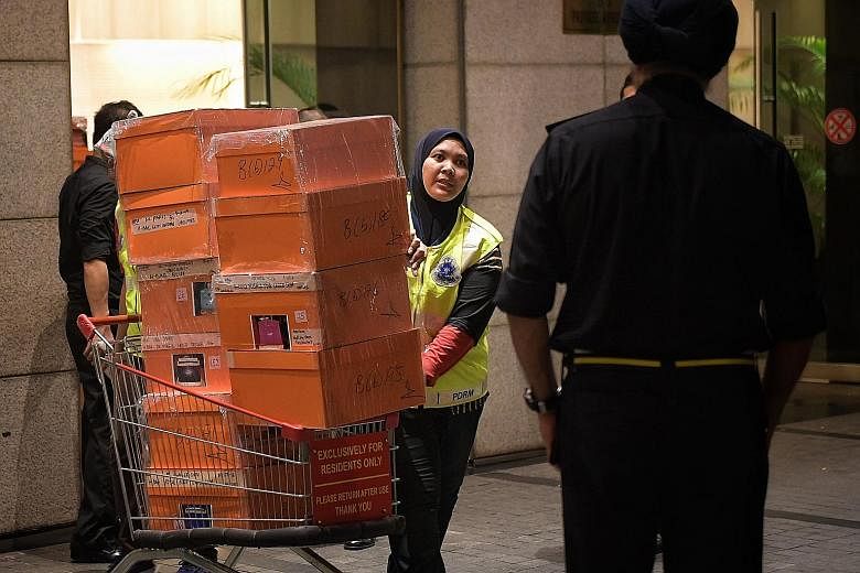 Boxes containing a large number of luxury handbags as well as bags filled with jewellery, cash, watches and other valuables were carted away during police raids on former Malaysian prime minister Najib Razak's home and condo units linked to his famil