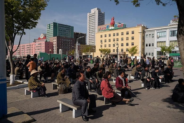 Far left: People in Pyongyang watching a public televised screening of a meeting of the ruling Workers' Party on April 21. North Korean leader Kim Jong Un said he would halt nuclear tests and missile launches, in an announcement welcomed by US Presid