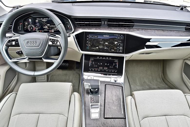 The interior of the Audi A6 sports open-pore wood inlays and aluminium trim accents as well as a highly digitalised dash and centre console.