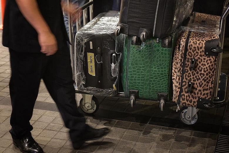 The police carted away bags filled with jewellery, cash, watches and other valuables, while many of the orange boxes were labelled with pictures and descriptions of different Hermes Birkin bags. Malaysian police removing items in a raid on Thursday n