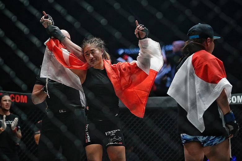 Angela Lee being announced the winner after a hard-fought win over Japan's Mei Yamaguchi during the One Championship atomweight title fight at the Singapore Indoor Stadium on Friday. Lee won by unanimous decision to retain her belt.