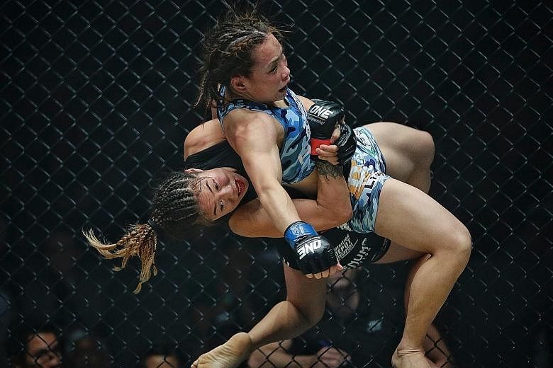 Angela Lee being announced the winner after a hard-fought win over Japan's Mei Yamaguchi during the One Championship atomweight title fight at the Singapore Indoor Stadium on Friday. Lee won by unanimous decision to retain her belt.