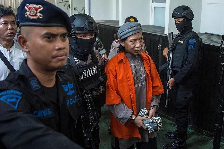 Heavily armed police officers escorting Aman Abdurrahman, who founded the JAD terror network in 2014, to a court hearing in Jakarta last Friday. Aman is said to be Indonesia's most dangerous terrorist ideologue. Zainal Anshori prior to his trial in J