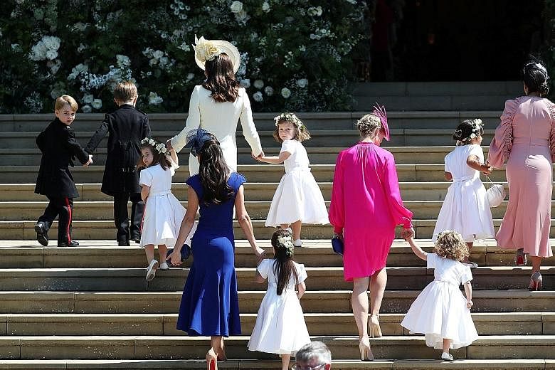 Ms Doria Ragland, Prince Charles and his wife Camilla, Prince William and his wife Catherine and their children, Prince George and Princess Charlotte, leaving the chapel after the wedding. The Duchess of Cambridge (in white) and other guests arriving