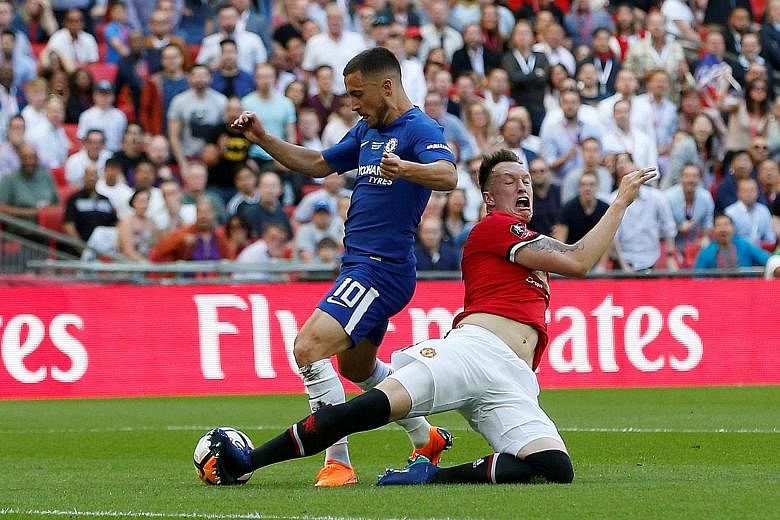 Top: Manchester United's Phil Jones fouling Chelsea's Eden Hazard in the penalty area. The defender earned a booking but also forced referee Michael Oliver into awarding Chelsea a penalty which Hazard scored for the game's only goal. Below: Chelsea's