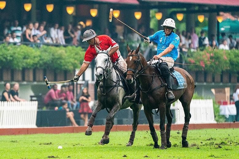 Singaporean Sattar Khan (in red), Prudential's team captain, chasing the ball while being challenged by his counterpart from Tata Communications Blue, Argentinian Carlos Pando, during the final of the Singapore Polo Open yesterday. Vinod Kumar put Ta