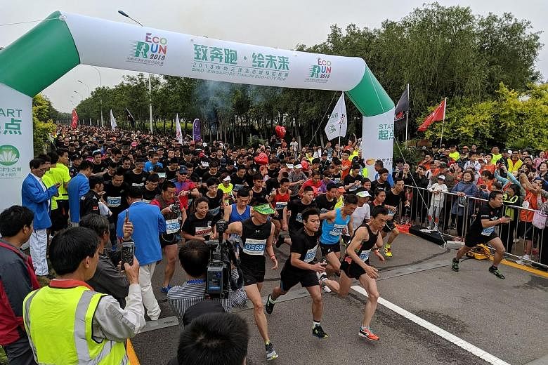 Residents of Tianjin Eco-City were treated to a weekend of carnival fun with activities such as a 100-drone light show on Saturday evening. The Sino-Singapore Tianjin Eco-City Eco Run capped a weekend of festivities as more than 1,000 runners took pa