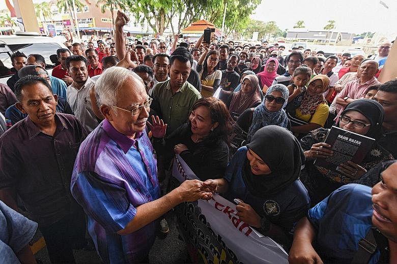Datuk Seri Najib Razak meeting supporters at an event in Pekan, Pahang, on Sunday. The former Malaysian premier, who has been summoned to the Malaysian Anti-Corruption Commission today, is expected to be questioned about fund transfers amounting to m