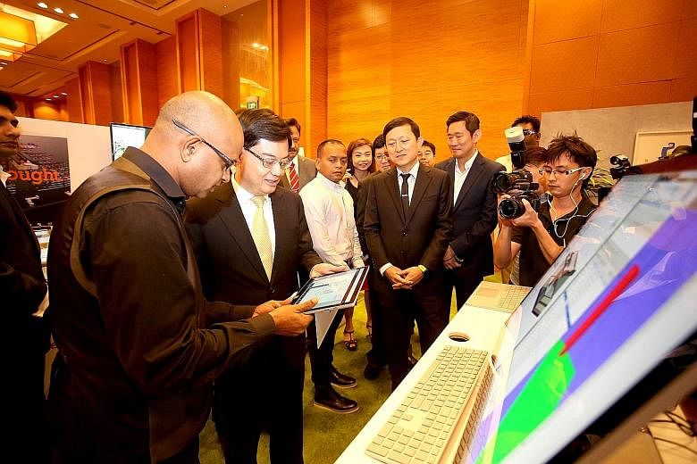 Finance Minister Heng Swee Keat visiting the Microsoft Singapore booth at the annual conference jointly held by the Board of Architects and the Association of Consulting Engineers Singapore yesterday.